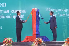 Thủ tướng Nguyễn Tấn Dũng và Thủ tướng Campuchia Hun Sen thực hiện nghi thức mở băng khánh thành Cột mốc 30 và đường nối hai trạm kiểm soát. (Ảnh: Trọng Đức/TTXVN)